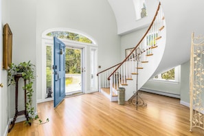 A staircase with white railings and wooden steps leading to an upper floor. - Swan Dive - Waterfront Retreat in Cataumet RPLO032 (Bourne)