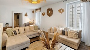 Een woonkamer met twee banken, een salontafel en een hanglamp.