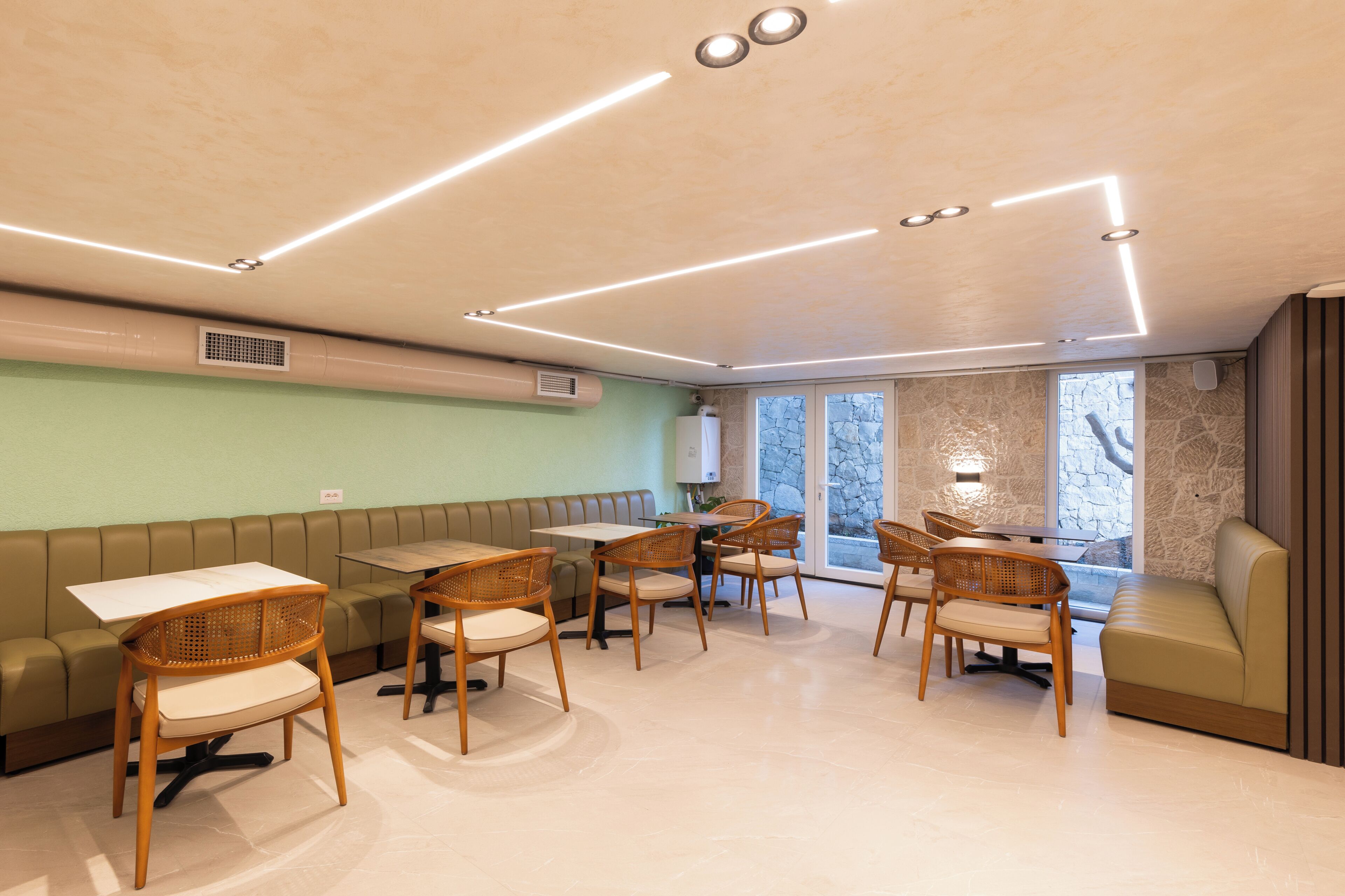 A modern interior with a seating area, tables, and chairs.