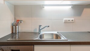 A modern kitchen with a stainless steel sink, a dishwasher, and a microwave above the counter. - Residence Sonngart Apartment A5 with View of Etschtal, Shared Pool, Hot Tub & Wi-Fi (Algund)