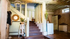 A staircase with a rustic design, a white radiator, and a stone floor. - Bed and Breakfast 'Chambre Bohème' with Private Terrace, Wi-Fi and Air Conditioning (Ryes)