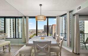 A dining area with a table, chairs, and a hanging light fixture. - New for 2026 - Beautiful 2 BR 2 BA Unit with Indoor Pool for Year Round Fun! (Ocean City)