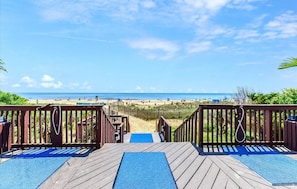 A wooden deck leading to a beach with a clear view of the ocean and beachgoers. - New for 2026 - Beautiful 2 BR 2 BA Unit with Indoor Pool for Year Round Fun! (Ocean City)