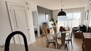 Eine moderne Küche mit Essbereich, einem großen Fenster und Blick auf die Stadt.