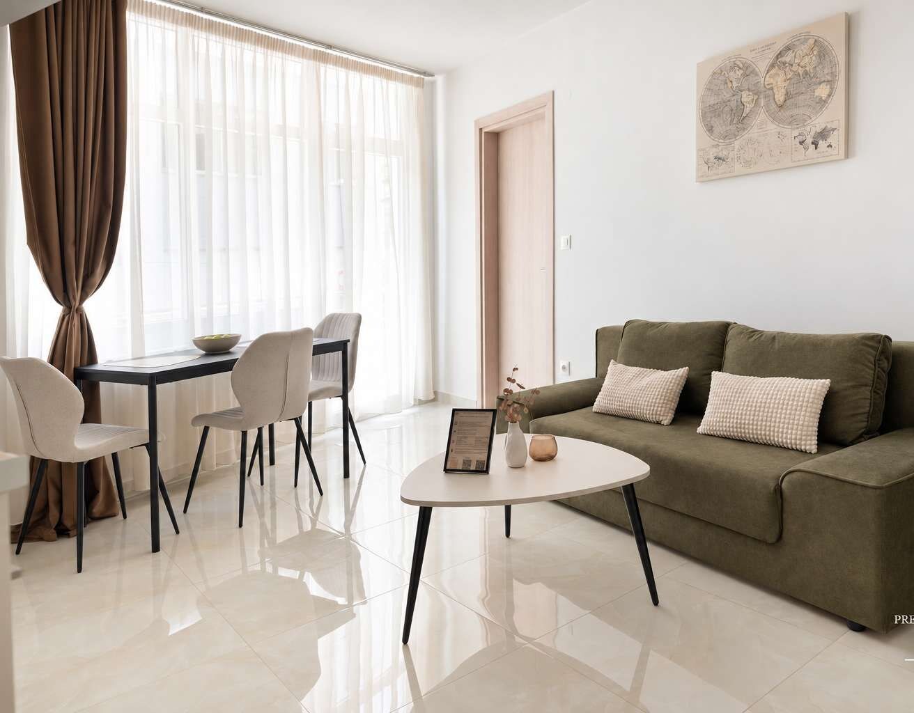 Relax in this beautifully arranged living area featuring a comfortable sofa, elegant coffee table and stylish dining space. Bright, exceptionally clean and thoughtfully furnished for a pleasant stay.
