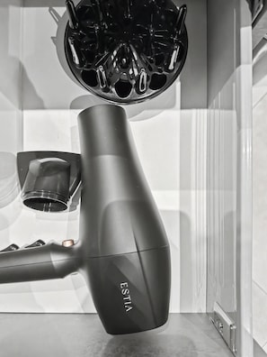 A hair dryer with a metallic nozzle and a sleek, modern design. - Estia Premium Apartments - Valouritou 52 Sqm2 Apartment (Thessaloniki)