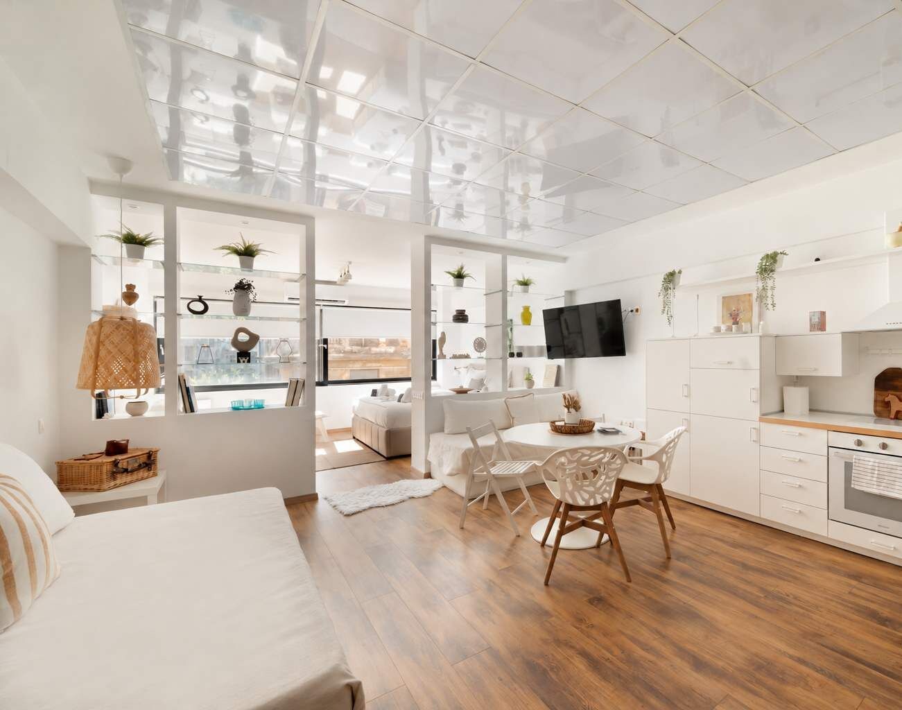A bright, open-plan living space with a comfortable sofa, dining table and thoughtfully chosen decor. Soft neutral tones and warm wood create a welcoming setting for relaxing after exploring the city. A welcoming place to feel at home.