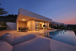 A modern house with a swimming pool, outdoor seating, and a patio area. - Villa D8 with private pool 1 km from sea (Tkon)