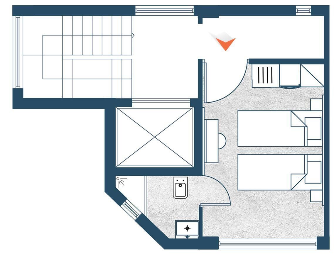 A hotel floor plan with a central lobby, multiple bedrooms, a bathroom, and a kitchen area.