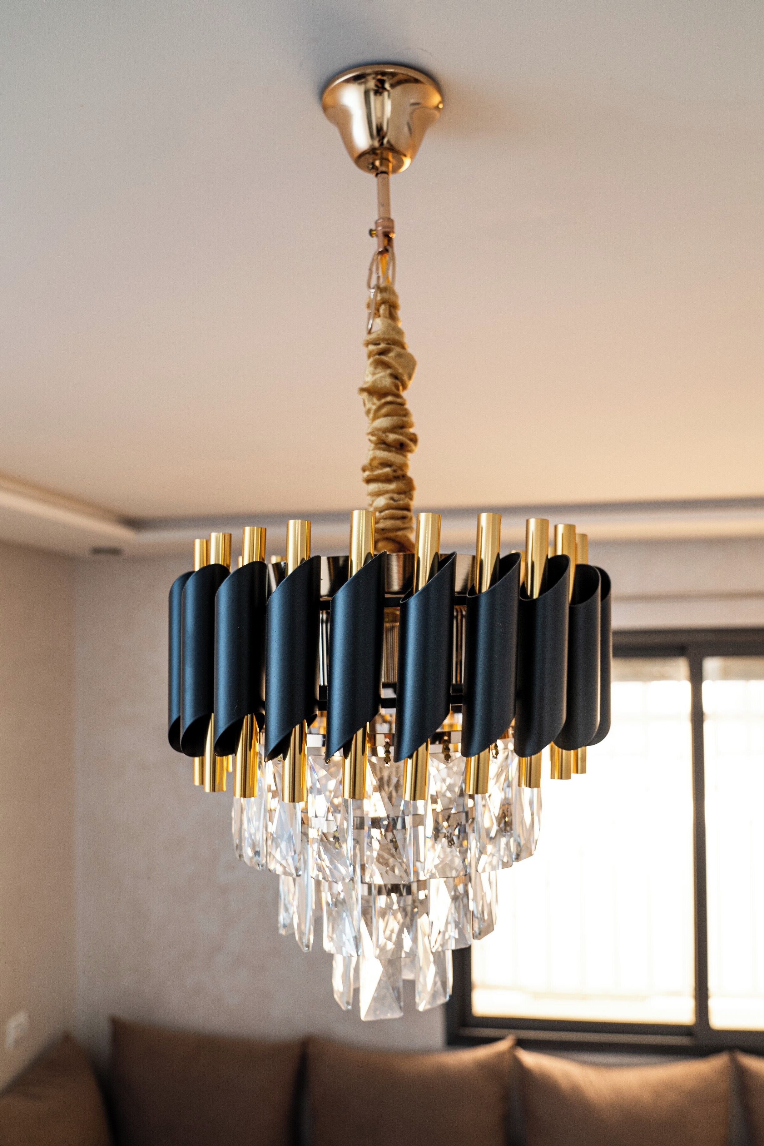 A chandelier with crystal elements and a twisted rope design.