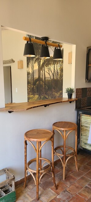 A bar area with two wooden stools, a wooden counter, and a mural of trees on the wall. - Charming country house in the heart of nature - Aubagne, au pied du Garlaban (Aubagne)