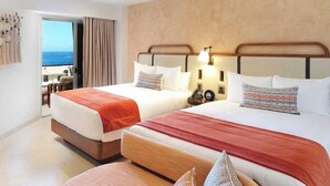 A hotel room with two beds, a wooden bench, a nightstand, and a view of the ocean. - Two bedroom Corazon suite with hot tub, and ocean view (Cabo San Lucas)