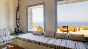 A room with a bed, a table, and a view of the sea. - Villa Kea Royale - Two Bedroom Villa, Sleeps 5 (Kastriani)