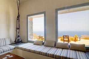 A room with a bed, a table, and a view of the sea. - Villa Kea Royale - Two Bedroom Villa, Sleeps 5 (Kastriani)