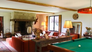 A cozy living room with a fireplace, a pool table, and comfortable seating. - La Faisane - Five Bedroom Villa, Sleeps 10 (Épaignes)