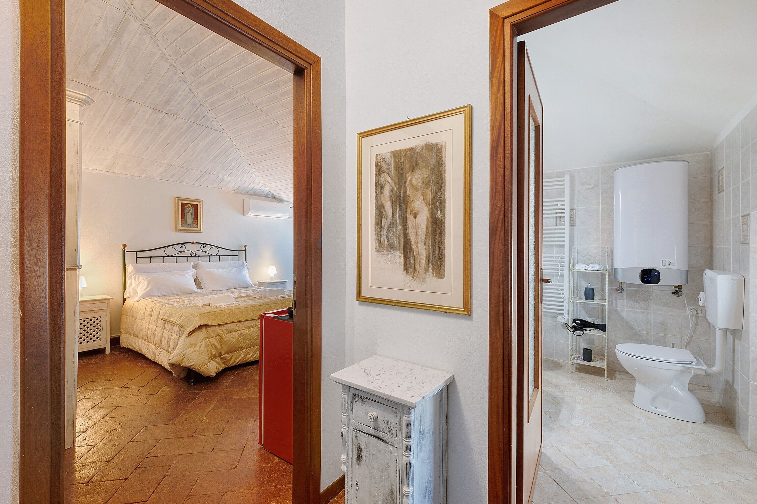 Ein Schlafzimmer mit Bett, Nachttisch und Beistelltisch.