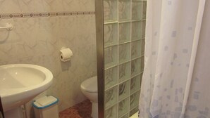 A bathroom with a white sink, toilet, and shower area. - La Torre del Palmar. (El Palmar)
