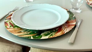 A dining table set with plates, glasses, and cutlery.