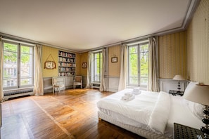 A spacious bedroom with a large bed, a desk, and a bookshelf. - 4 bedrooms/Castle/Garden/Montmartre (Paris)