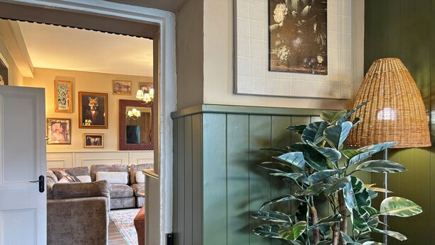 A room with a green cabinet, a large plant, and a wicker lamp. - Property 472 - Kylemore - sleeps 20 guests  in 11 bedrooms (Kylemore)