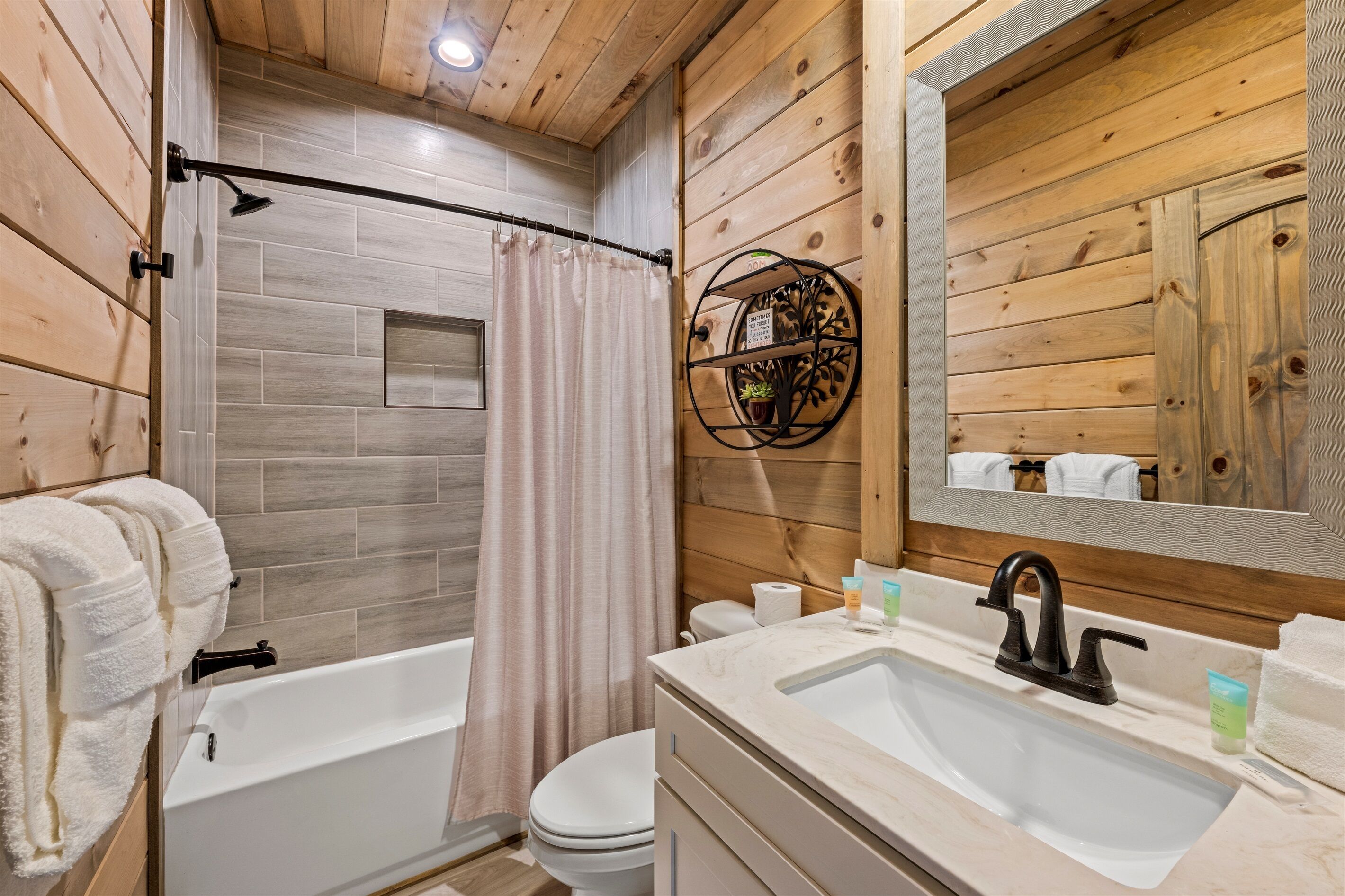 A bathroom with a bathtub, toilet, and sink.