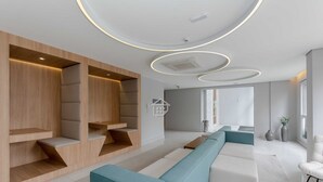 Ett modernt hotellrum med inbyggda sittplatser, ett stort fönster och en minimalistisk design.