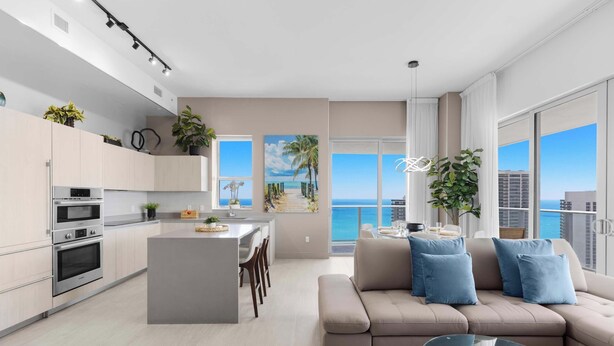 Un apartamento moderno con cocina, comedor y sala de estar, con ventanas amplias y vista al océano.