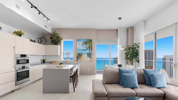 A modern apartment with a kitchen, dining area, and living room, featuring large windows and a view of the ocean. - High Floor 2BR and 2 BA, Free Parking (Hollywood)