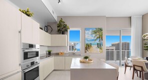 A modern kitchen with built-in appliances, a central island, and a dining area with a view of the city. - High Floor 2BR and 2 BA, Free Parking (Hollywood)