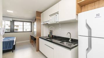 Fridge, microwave, coffee/tea maker, cookware/dishes/utensils