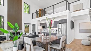 A modern interior with a dining area, kitchen, and living space.