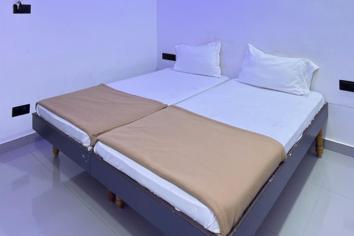 A modern bedroom with a bed, a ceiling fan, and LED lighting.