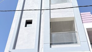 A building with a sign reading 'Mahindra Home Stay' in English and another language.
