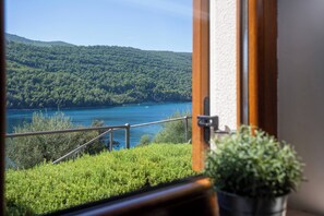 A view of a lake with a forested hillside, a railing, and a potted plant. - 210 Sea Side 2bedrooms Holiday Apartment SeaView (Duga Luka)