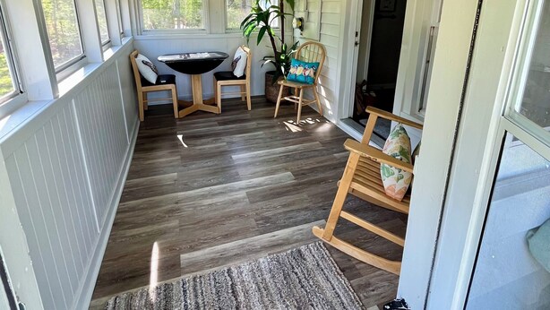 A covered porch with a ceiling fan, a table with chairs, a rocking chair, and a potted plant. - NEW RENTAL-GREAT RATES! Peaceful 2B-1.5B cottage- 0.4 mile to FCF State Park (Pikeville)