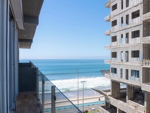 A view of the ocean from a balcony with a clear sky. - Luxurious 2 bedroom condo with partial ocean view (Mazatlan)