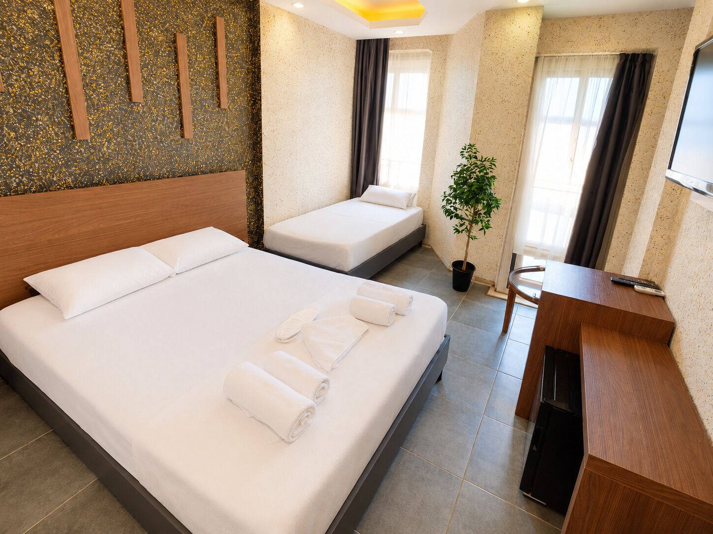Habitación triple Deluxe, balcón, vistas parciales al mar | Minibar, wifi gratis, ropa de cama