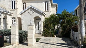 A building with a stone facade, a central entrance, and a sign indicating 'PARK ROAD.' - 2-bedroom townhome in tranquil Belair with cool Atlantic breeze (Belair)