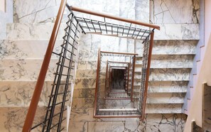 A marble staircase with a metal handrail and a metal safety rail. - 3BR Family Apartment by Propertize (Cagliari)
