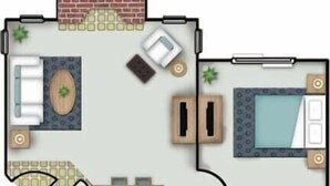 Ein Hotelzimmer mit Bett, Sitzecke, Küchenzeile und Badezimmer.
