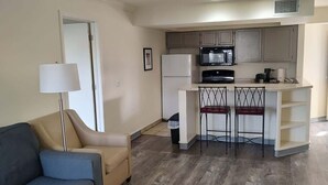 A modern apartment with a living room, a kitchenette, and a dining area. - Two Bedroom First Floor (Wichita)