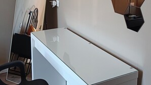 A modern office desk with a mirror, a chair, and a hexagonal wall decoration. - Double room with private bathroom (La Spezia)