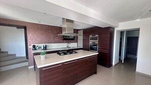 A modern kitchen with dark wood cabinets, a central island, a built-in oven, and a stainless steel range hood. - 🌴 SPECIAL SUMMER CLOSING SALE: 30% off from August 22 to August 29 🌴 (Ollioules)