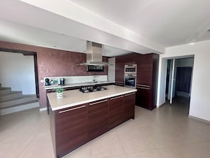 A modern kitchen with dark wood cabinets, a central island, a built-in oven, and a stainless steel range hood. - 🌴 SPECIAL SUMMER CLOSING SALE: 30% off from August 22 to August 29 🌴 (Ollioules)