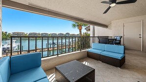 A balcony with a view of a marina, a ceiling fan, and a sofa. - 5 Minutes to the beach!
Beautiful 2-bedroom Condo in St Pete (St. Petersburg)