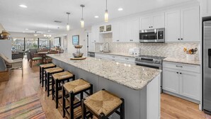 A modern kitchen with white cabinets, a granite countertop, and stainless steel appliances. - 5 Minutes to the beach!
Beautiful 2-bedroom Condo in St Pete (St. Petersburg)