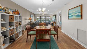 A dining area with a round table, chairs, and a chandelier. - 5 Minutes to the beach!
Beautiful 2-bedroom Condo in St Pete (St. Petersburg)