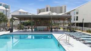 A swimming pool with a covered seating area and lounge chairs. - Orange Beach / Cotton Bayou Waterfront / Pool / Boat Slip & Launch/Beach Access (Orange Beach)