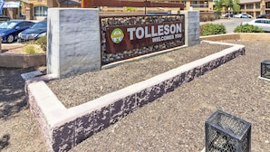 A sign welcoming visitors to Tolleson with a logo and a clear view of the surrounding parking area. - New Cozy Studio Fast WiFi & Work Desk (Tolleson)