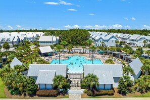 A resort with multiple buildings, a central swimming pool, and palm trees. - Big Chill Bungalow @ Prominence On 30a- walk to the Big Chill- 4 Bikes Provided (Inlet Beach)